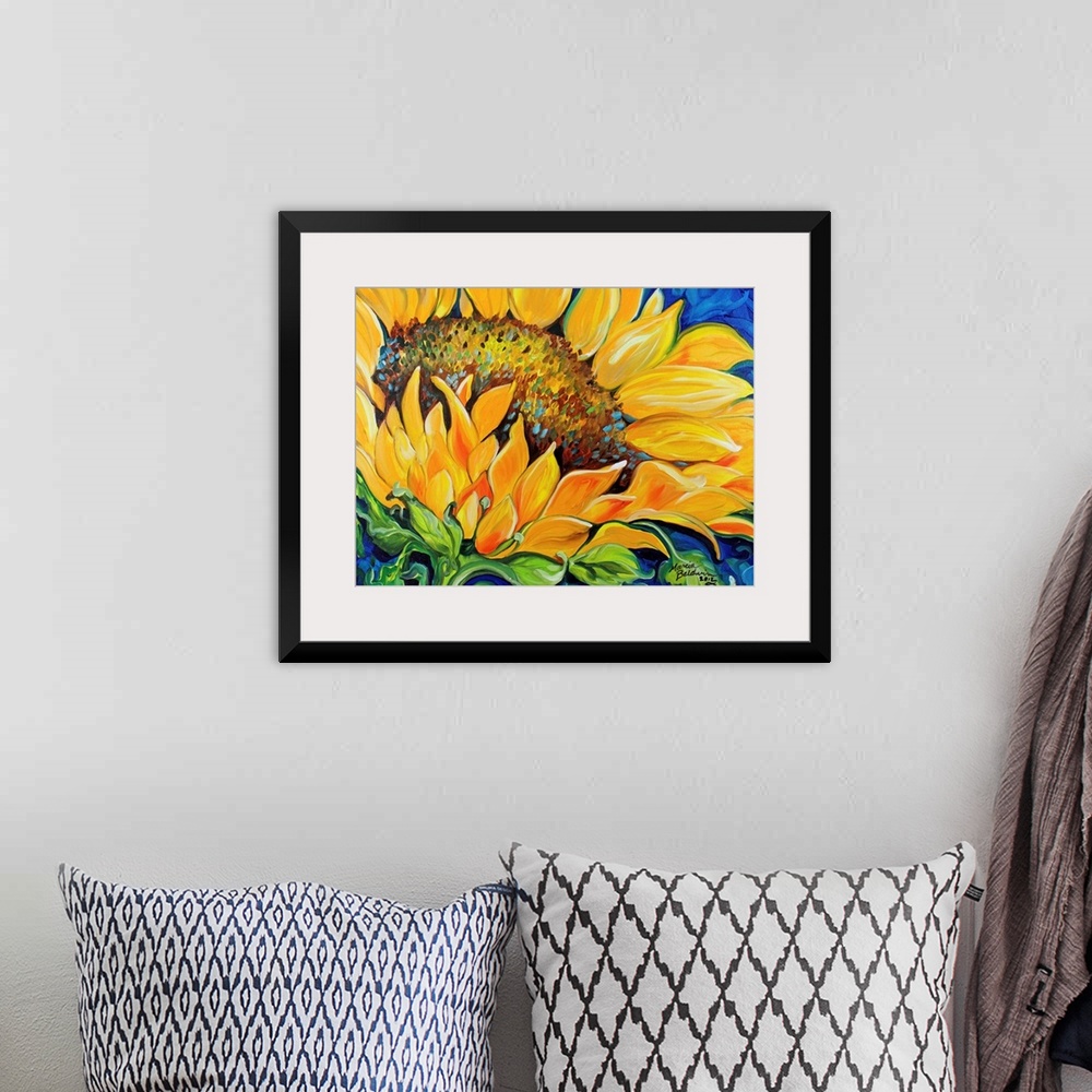 A bohemian room featuring Contemporary painting of a sunflower up close on a blue background.