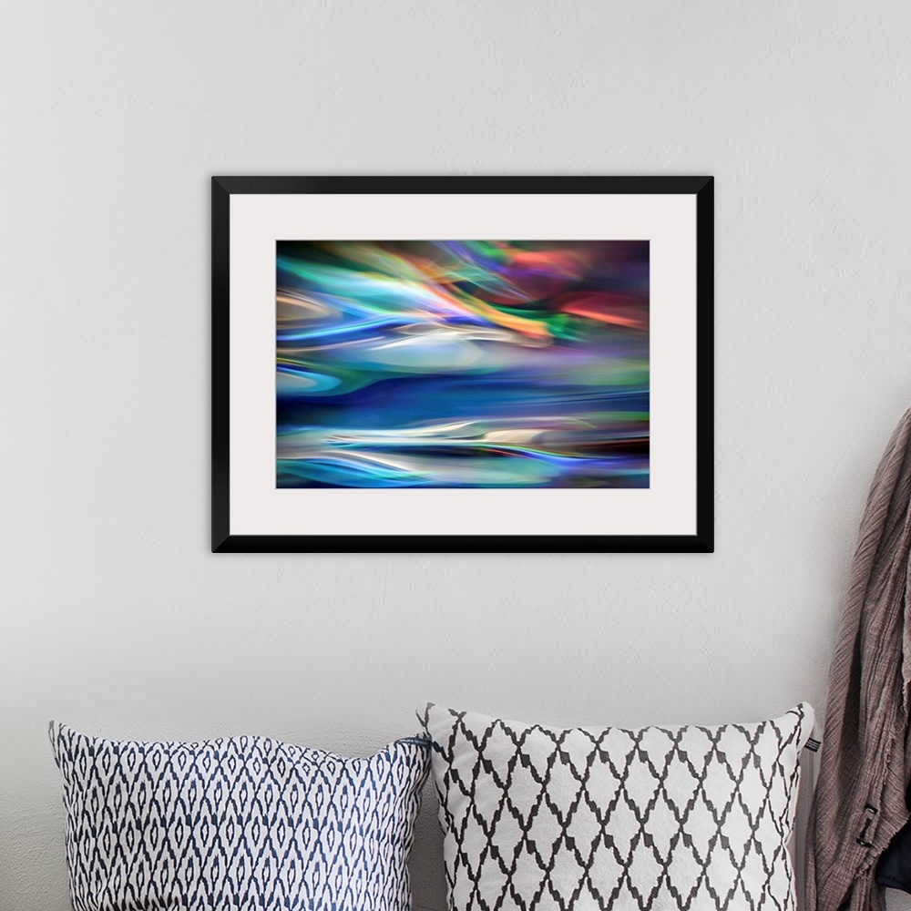 A bohemian room featuring Wall art that has moving multicolored lines that are composed in an abstract fashion.
