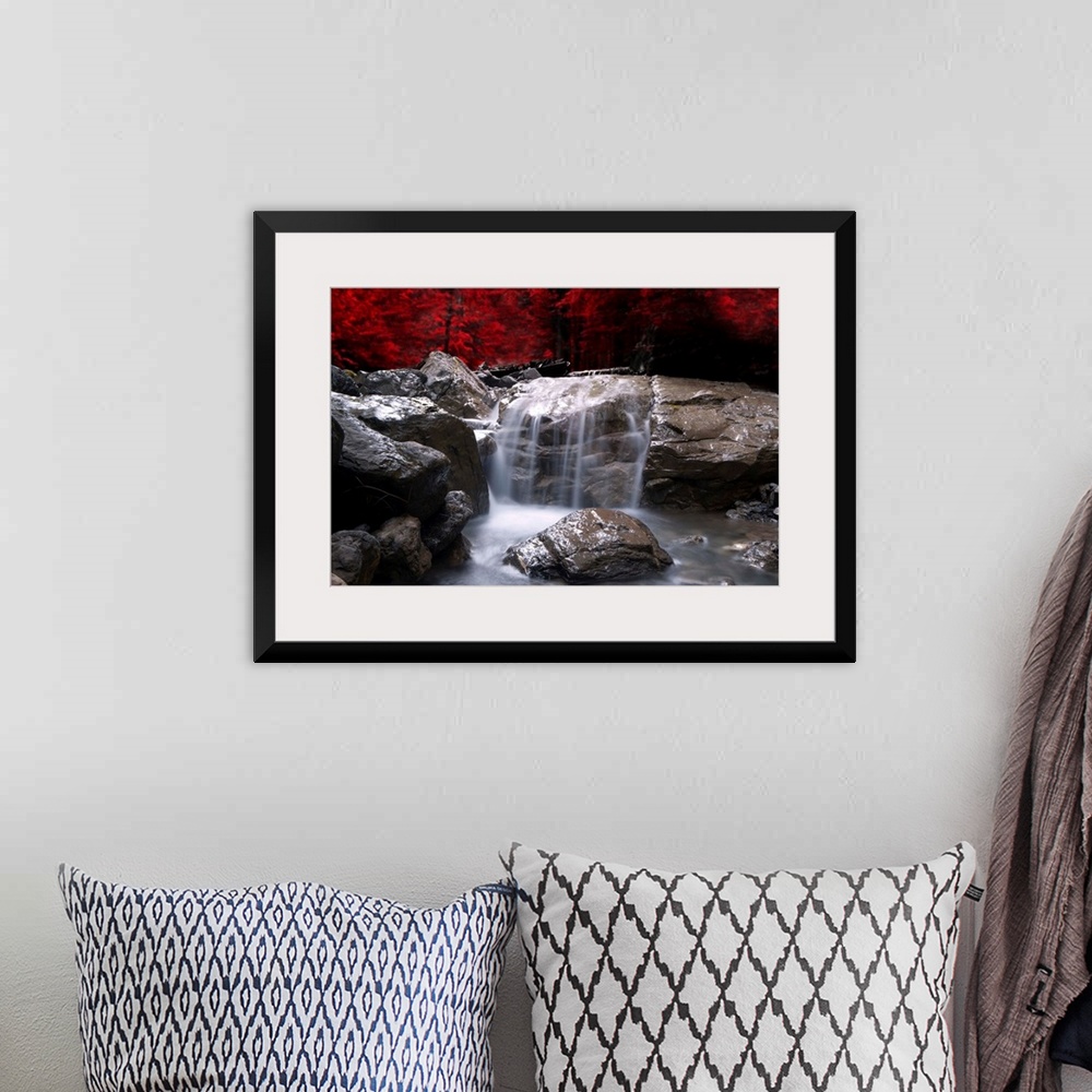 A bohemian room featuring A waterfall in front of a red autumn forest