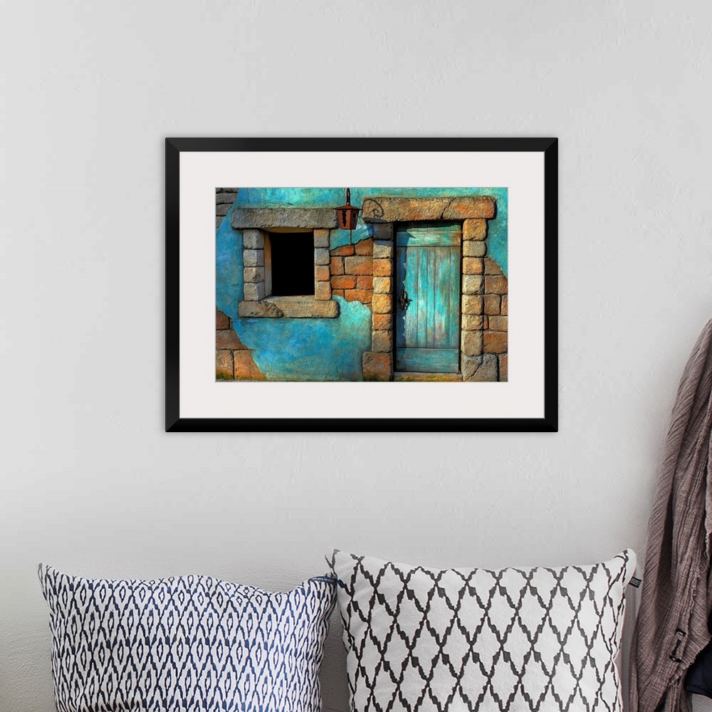 A bohemian room featuring Landscape fine art photograph highlighting a door surrounded by a stone wall and window.
