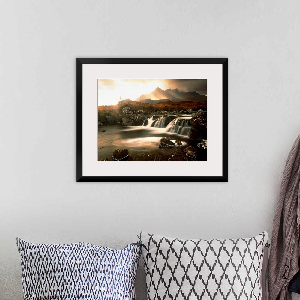 A bohemian room featuring Time lapsed photograph of water flowing through a rocky river while the sun glows behind clouds i...