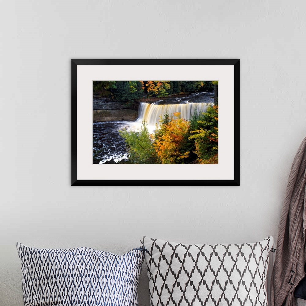 A bohemian room featuring Giant, horizontal photograph of Tahquamenon Falls surrounded by colorful fall foliage in Michigan.