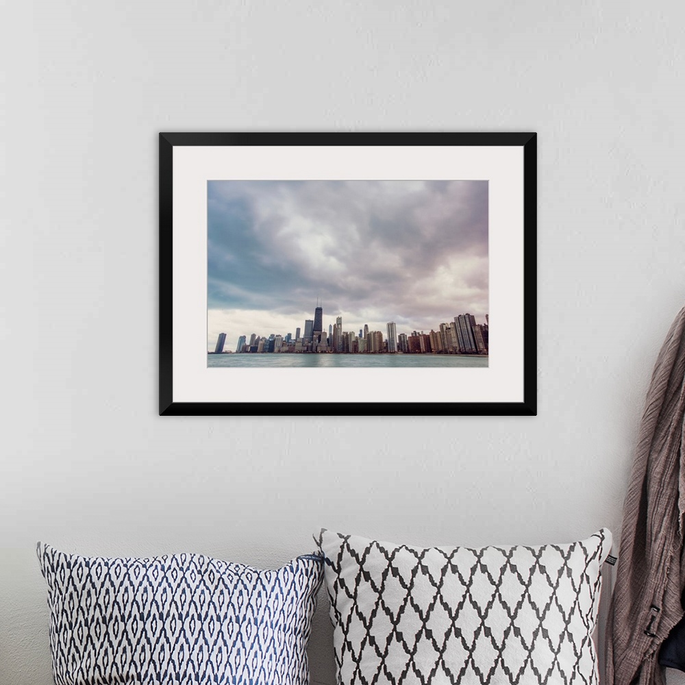 A bohemian room featuring Photo of Chicago's skyline under dramatic clouds.
