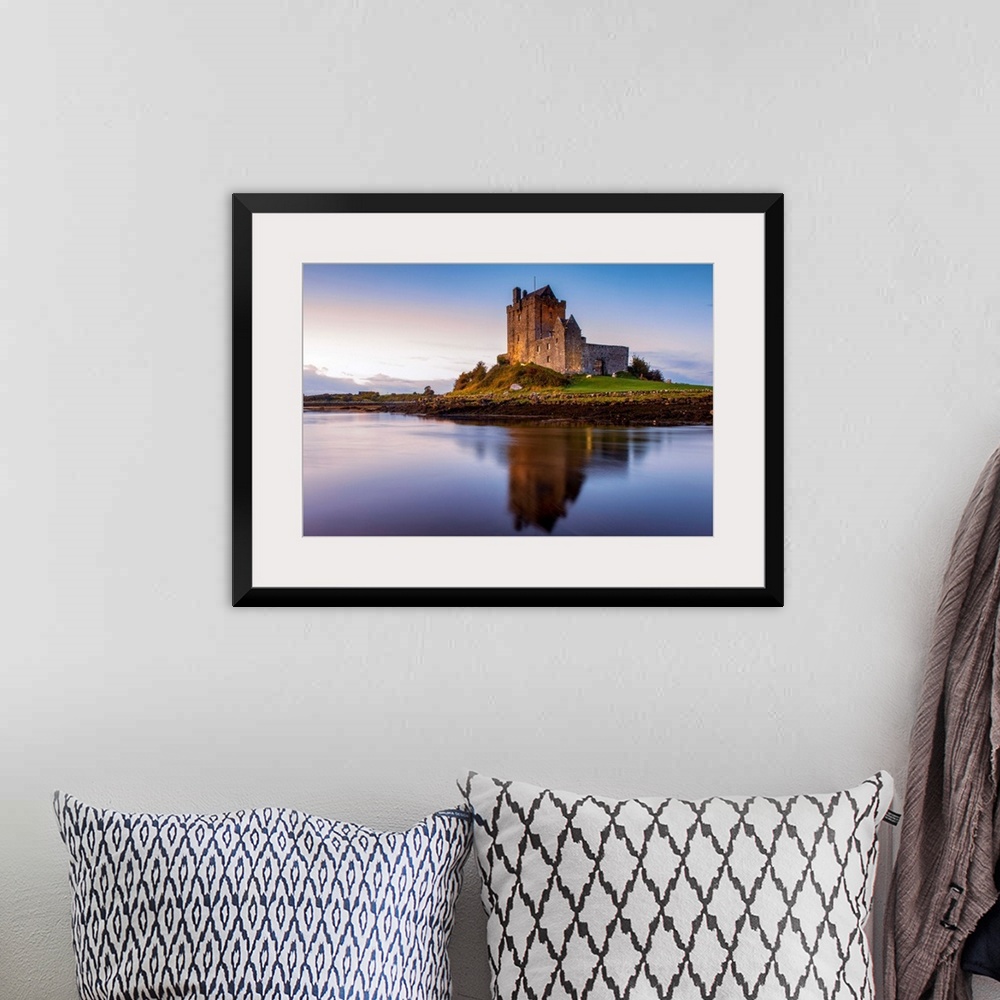 A bohemian room featuring Landscape photograph of the Dunguaire Castle reflecting into the water on the southeastern shore ...