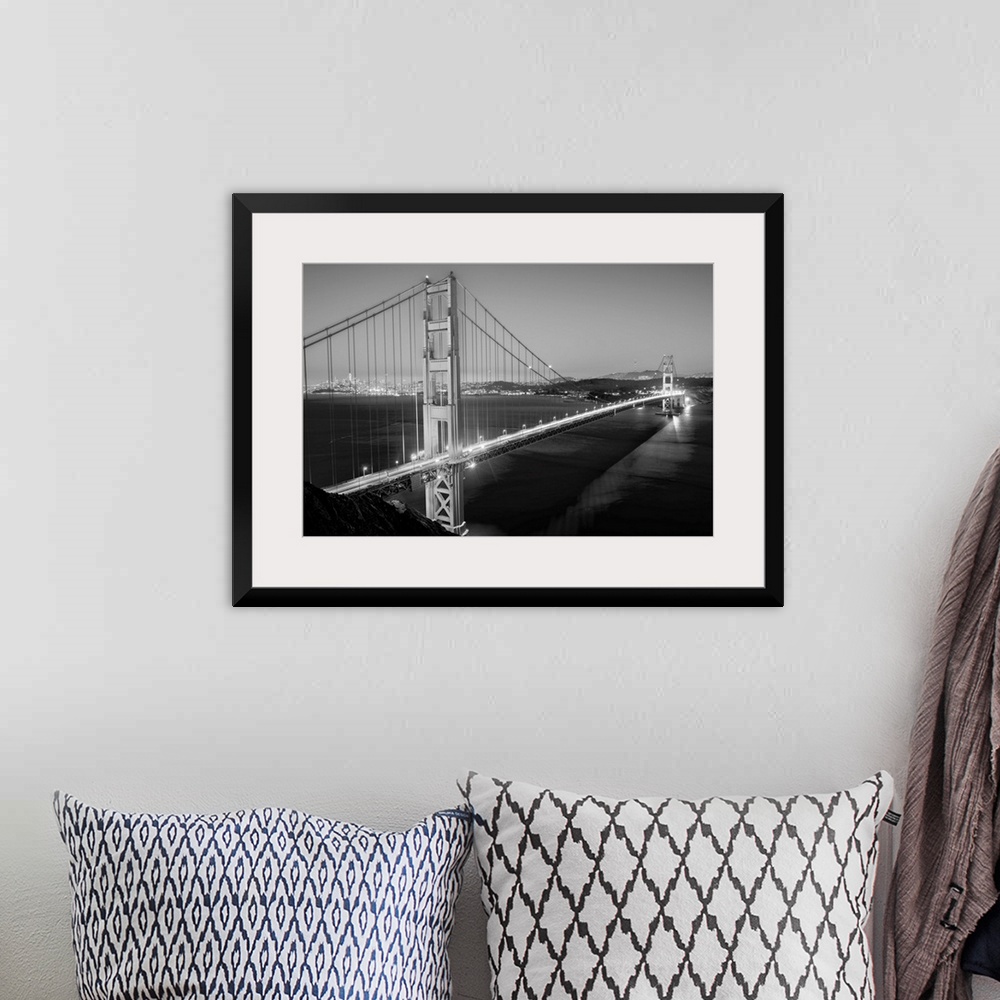 A bohemian room featuring Cool toned photograph of the Golden Gate Bridge lit up at twilight with the city lights in the ba...