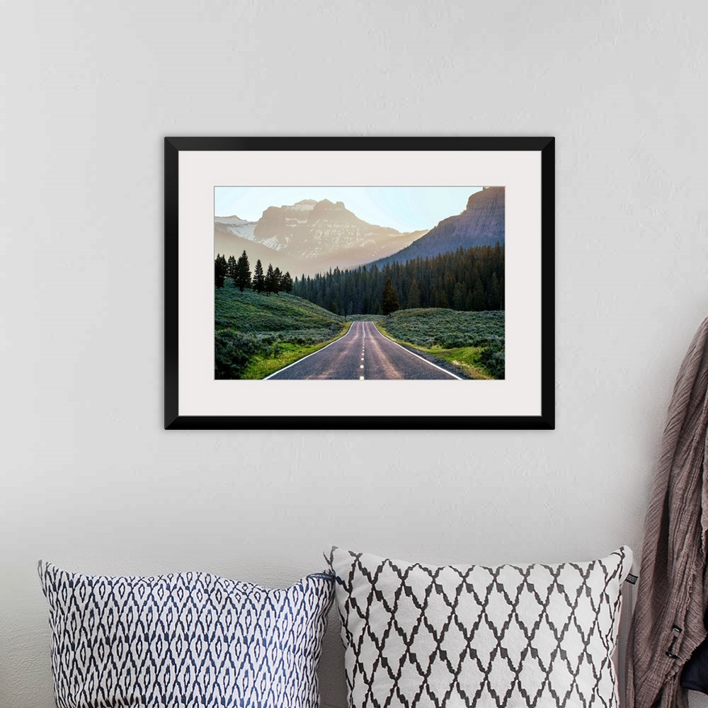 A bohemian room featuring Horizontal image of a road heading to the mountains at Yellowstone National Park.