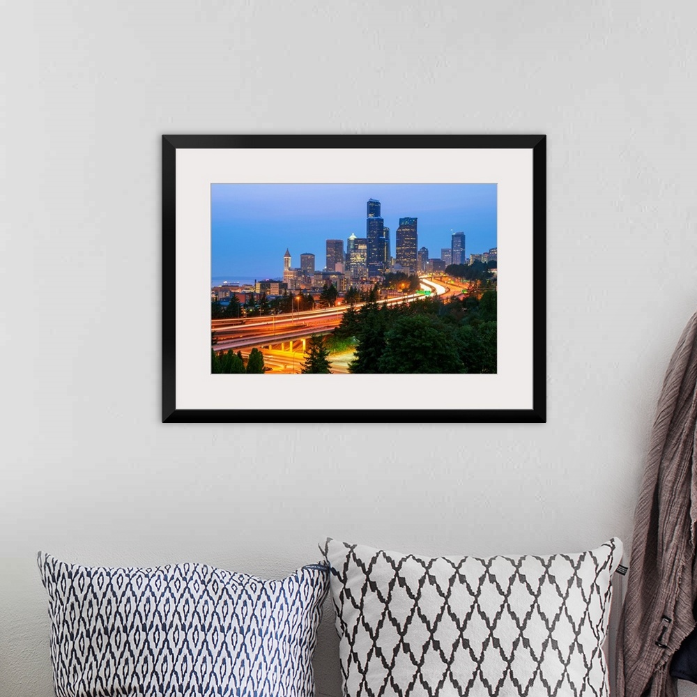 A bohemian room featuring Photograph of the Seattle skyline at dusk with light trails from the cars on the highway in the f...