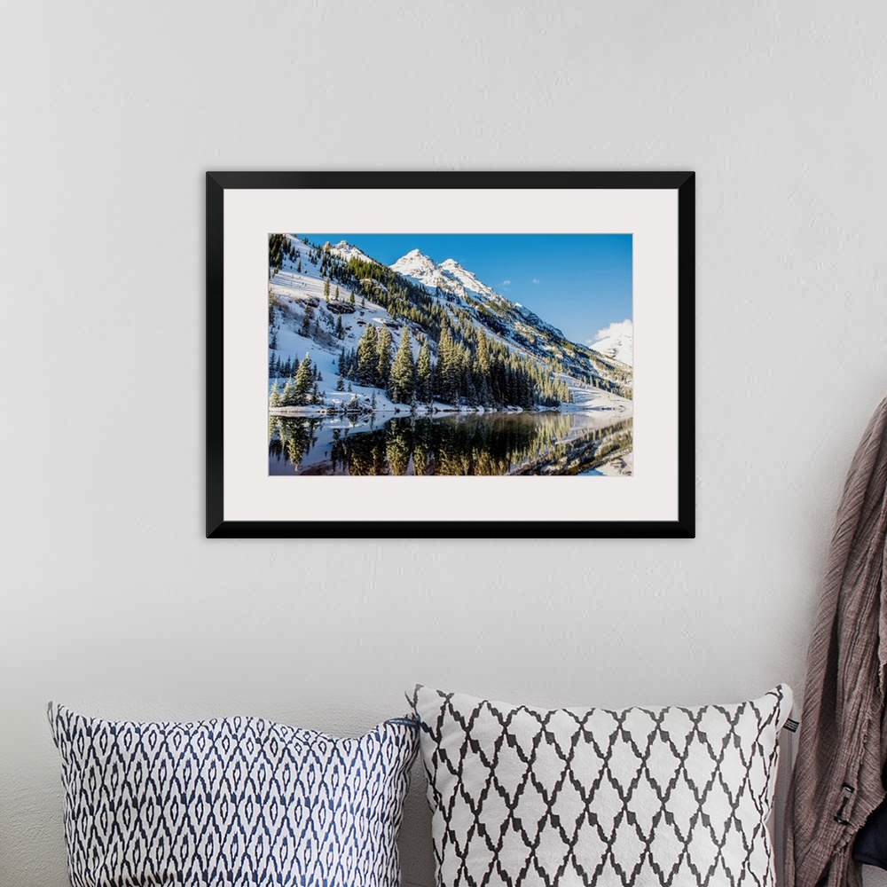 A bohemian room featuring Summer snow on pine trees and the mountain side at the edge of Maroon Lake in the Maroon Bells, A...