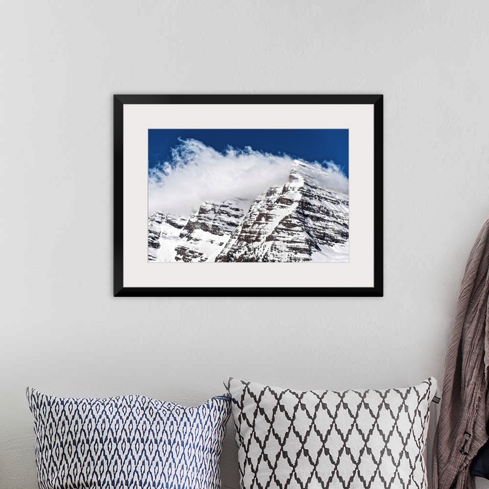 A bohemian room featuring Wind-blown snow on the peaks of the Maroon Bells under a blue sky in Aspen, Colorado.