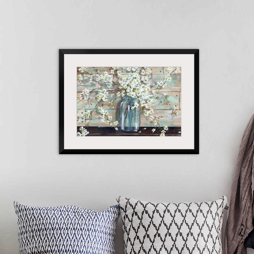 A bohemian room featuring A decorative painting of a glass mason jar full of white blossoms in subdue tones.