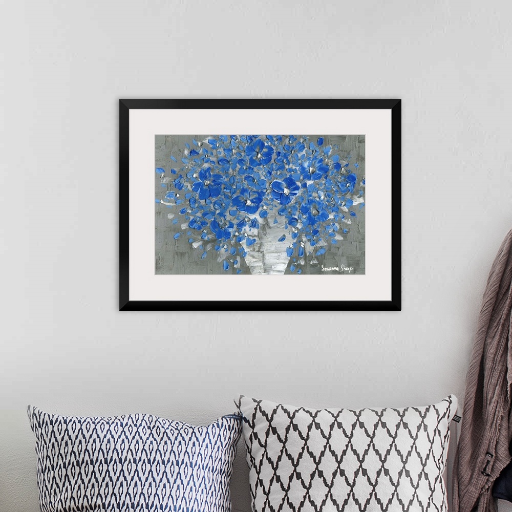 A bohemian room featuring Contemporary painting of a bouquet of blue flowers with silver highlights in a white vase with a ...
