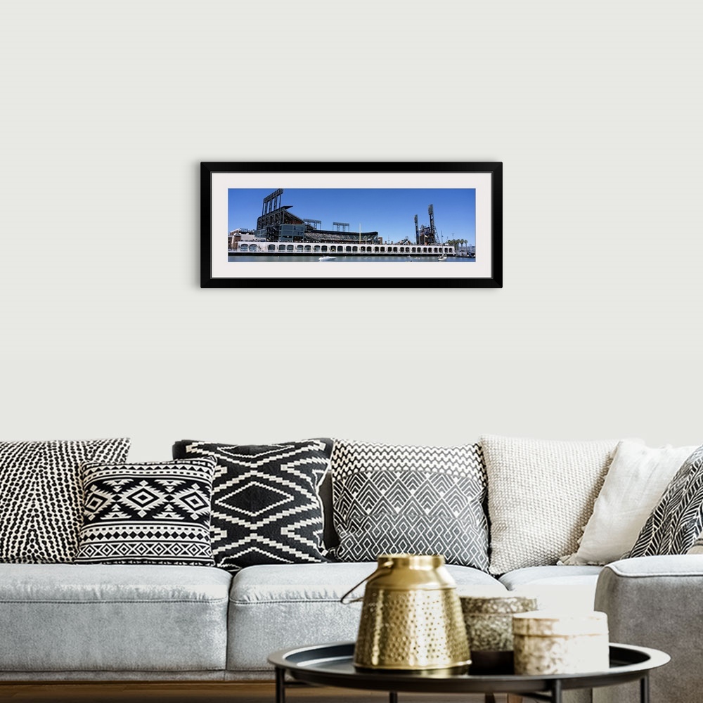 A bohemian room featuring The San Francisco Giants baseball stadium is photographed from the waterfront view.