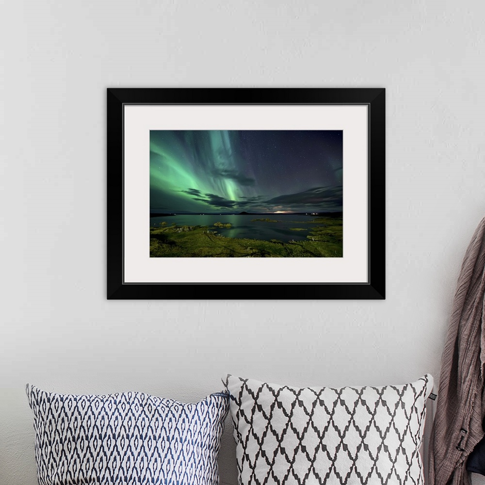 A bohemian room featuring The northern lights seen above Myvatn Lake in Iceland at night.