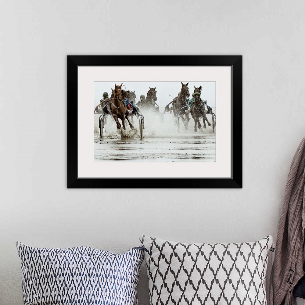A bohemian room featuring Action shot of a harness race, where horses pull a two-wheeled cart called a sulky.