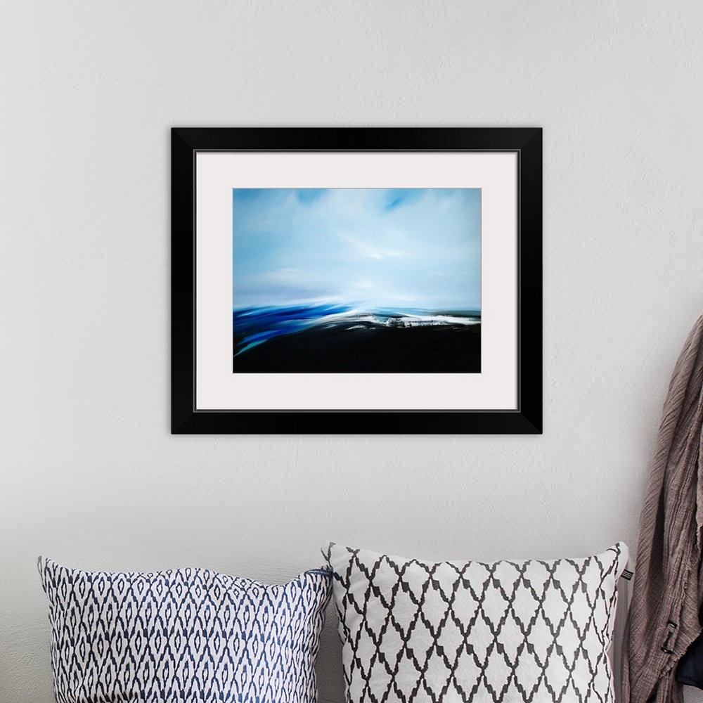 A bohemian room featuring A seascape with stark contrast between the dark see and light sky.