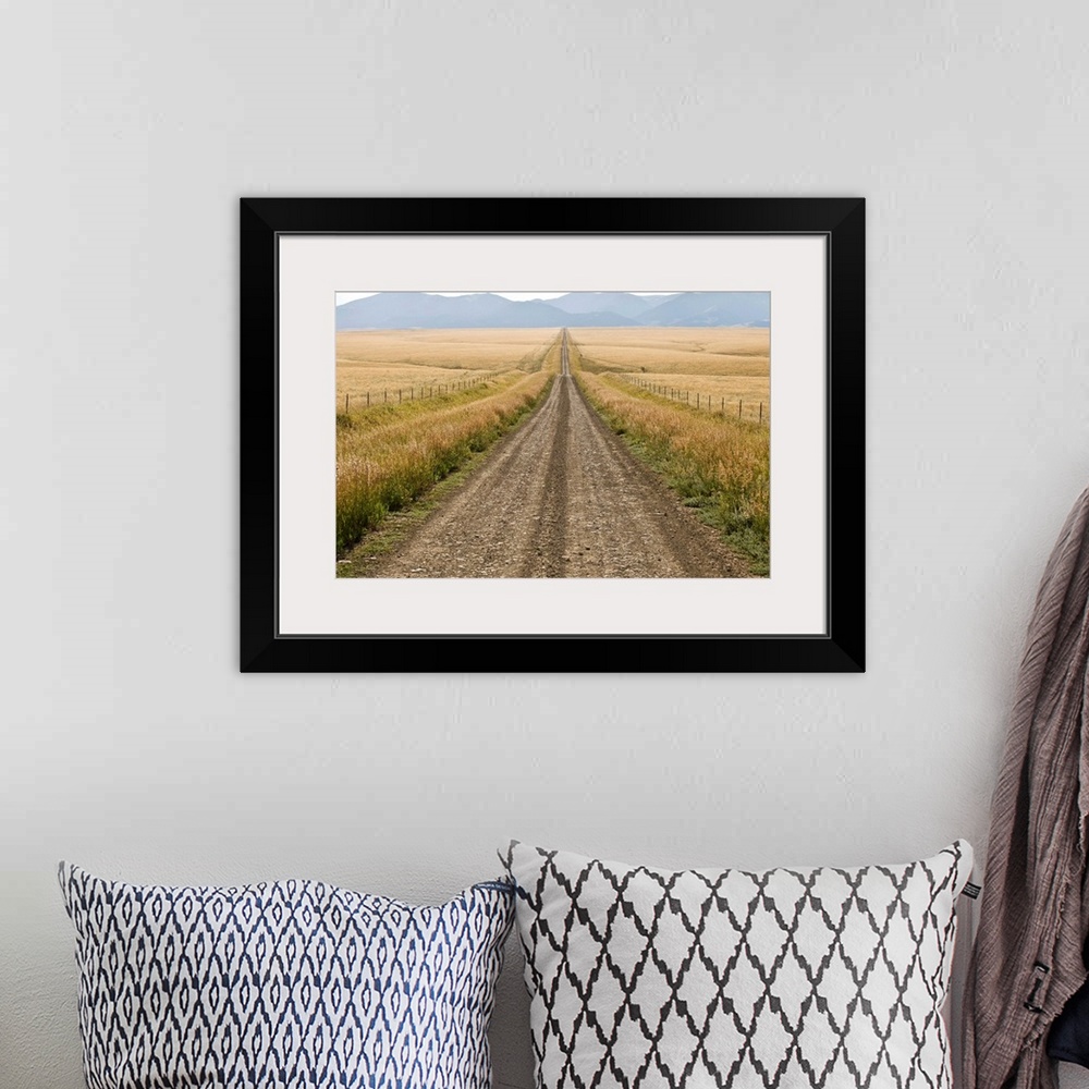 A bohemian room featuring A road cuts through a prairie in the Crazy Mountains.