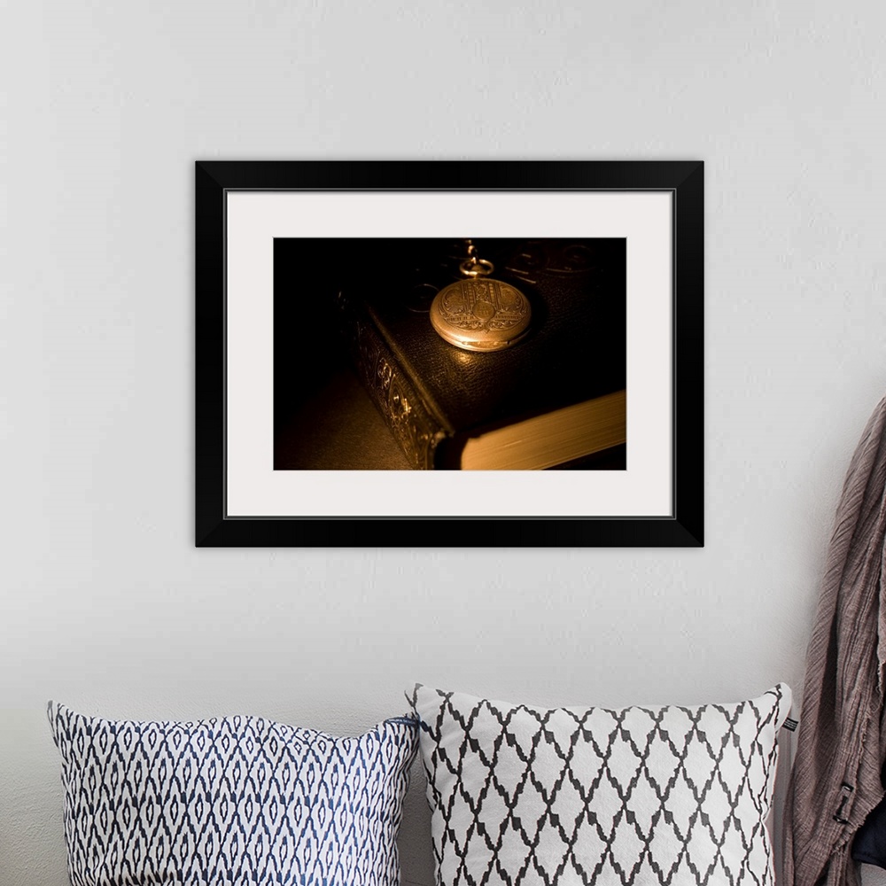 A bohemian room featuring Gold Pocket Watch Resting On A Book