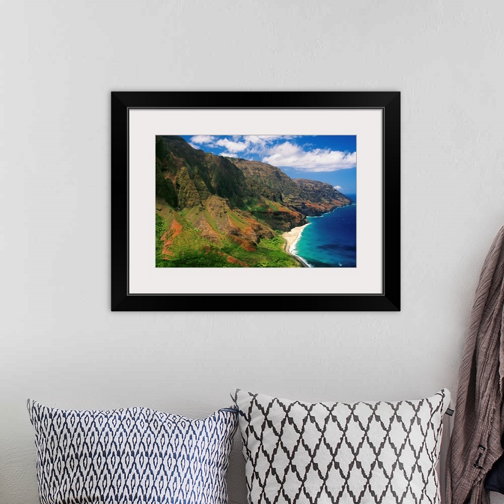 A bohemian room featuring Immense cliffs that line the Hawaiian coast are photographed on a bright sunny day.