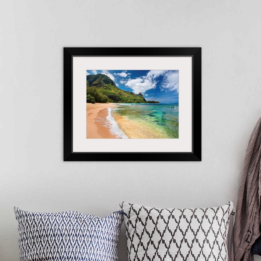 A bohemian room featuring Big photograph shows the clear waters of the Pacific Ocean slowly making their way to the sandy s...