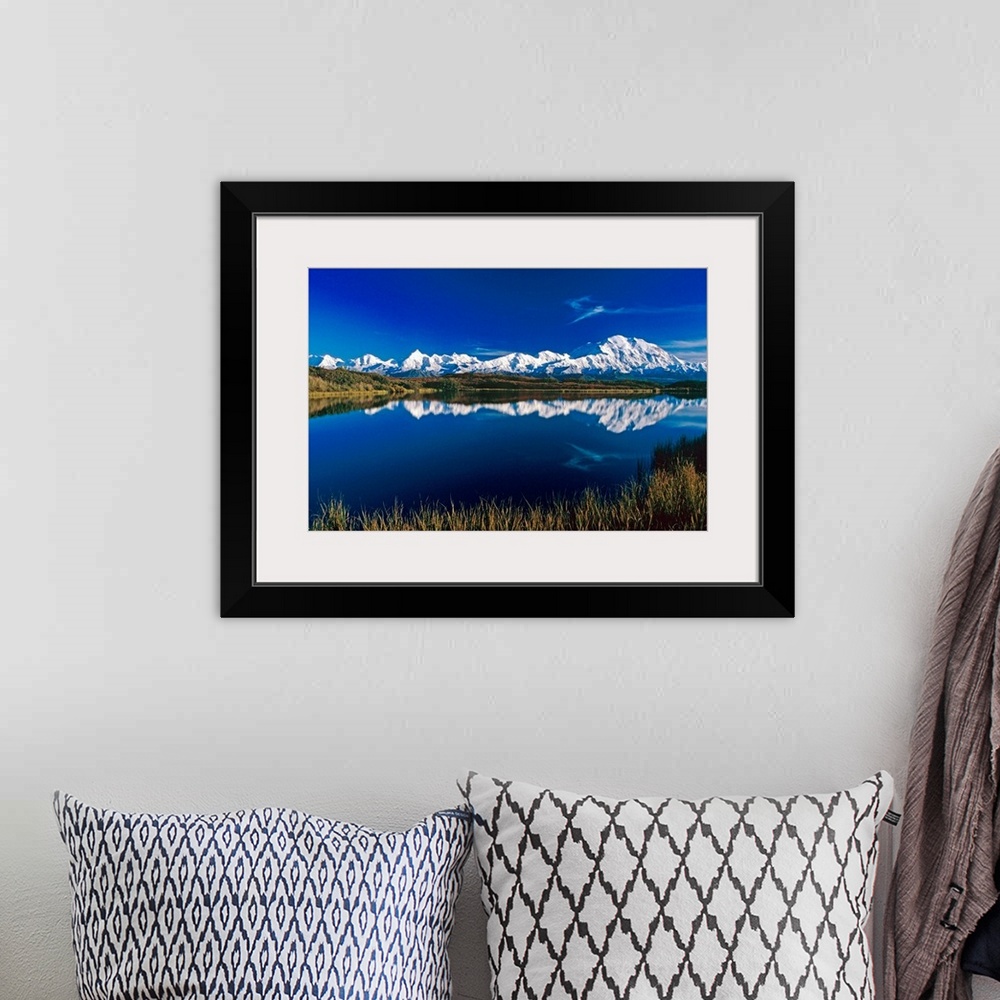 A bohemian room featuring Photograph of snow covered mountain range with waterfront.  The sky is clear and the mountains ar...