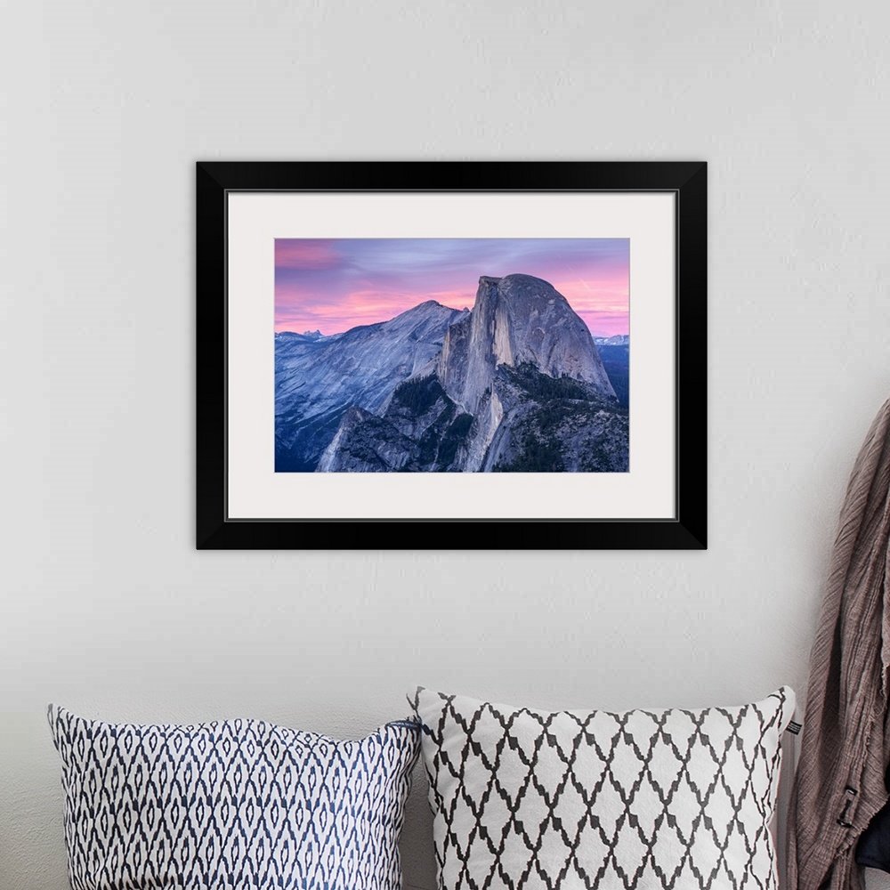 A bohemian room featuring Half Dome in Yosemite with pink clouds in the sky.