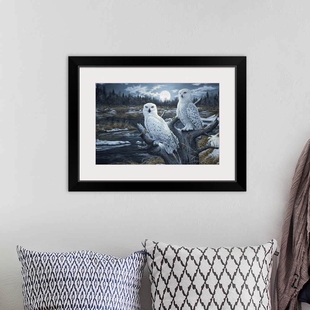 A bohemian room featuring a pair of white owls perched in the top of a dead tree with the moon rising in the background