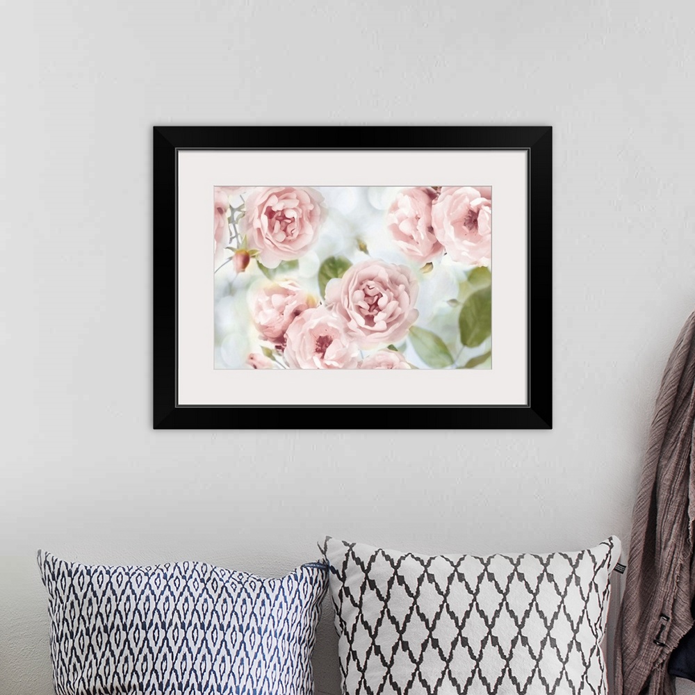 A bohemian room featuring Decorative artwork featuring soft flowers in shades of pink over a bokeh background.