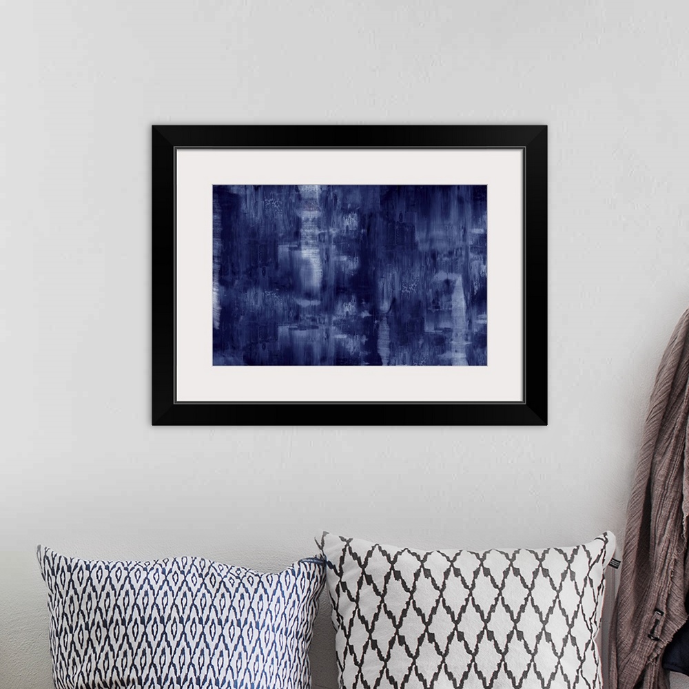 A bohemian room featuring Large abstract painting created with deep indigo hues and small streaks of white.