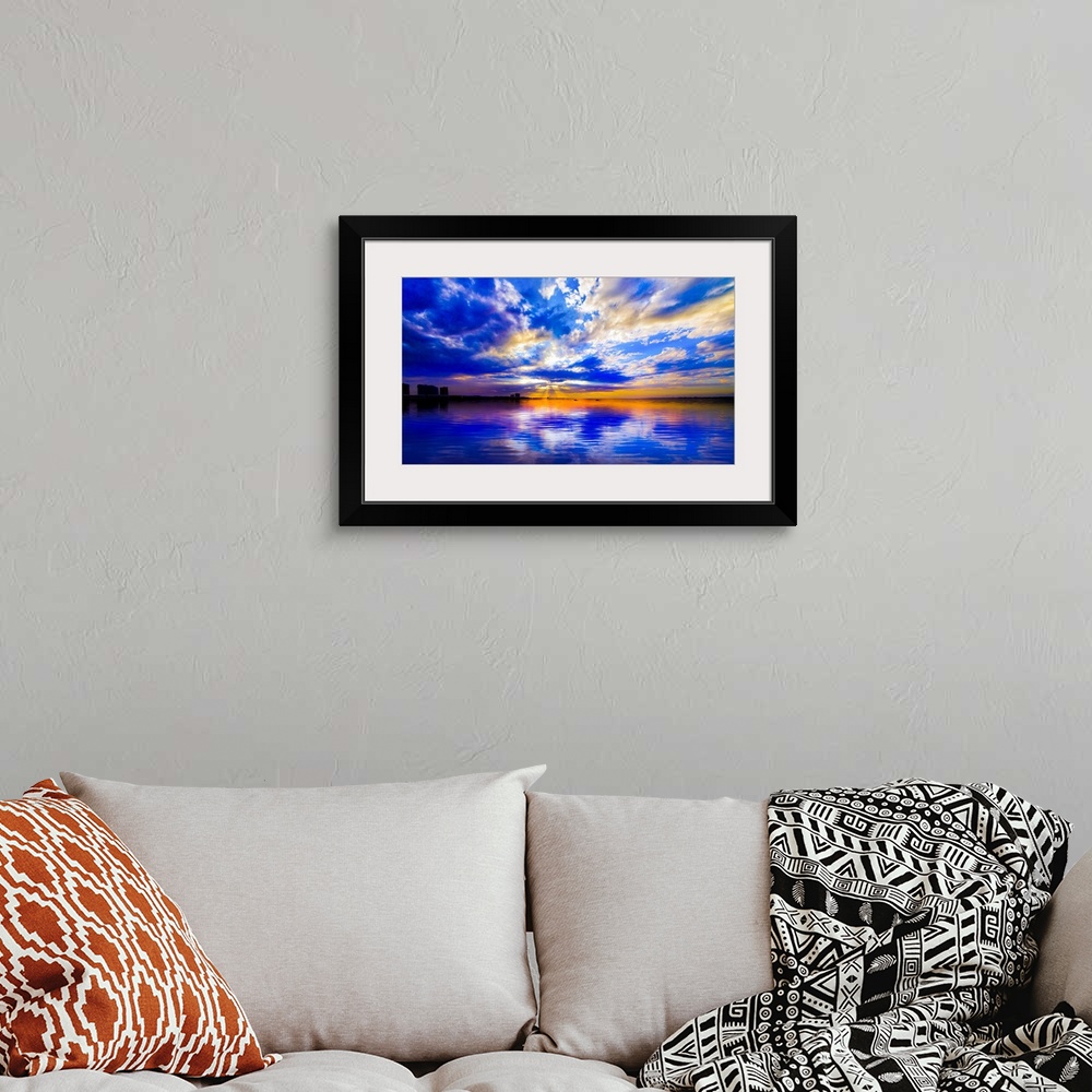 A bohemian room featuring The sunset reflected in this blue and white seascape during sunset.