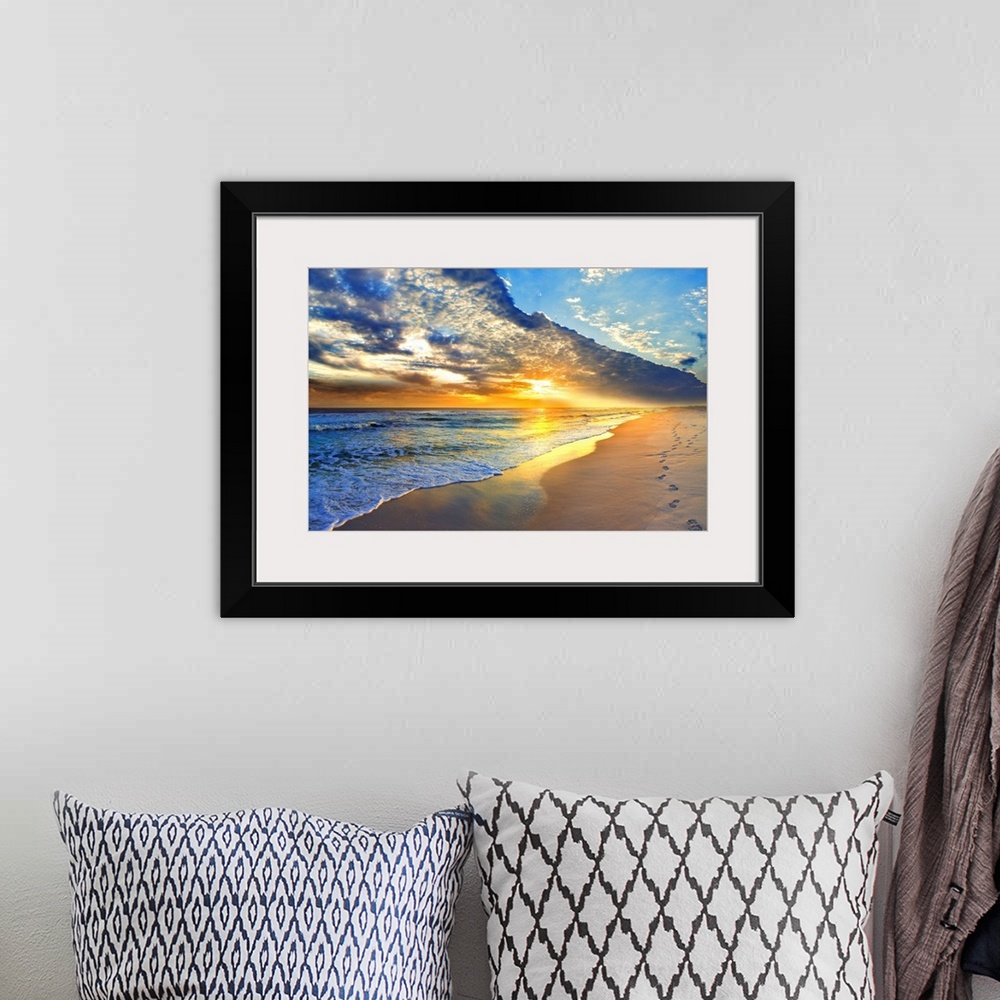 A bohemian room featuring Bright golden sunset casts light onto the beach and blue seascape below. Landscape taken on Navar...