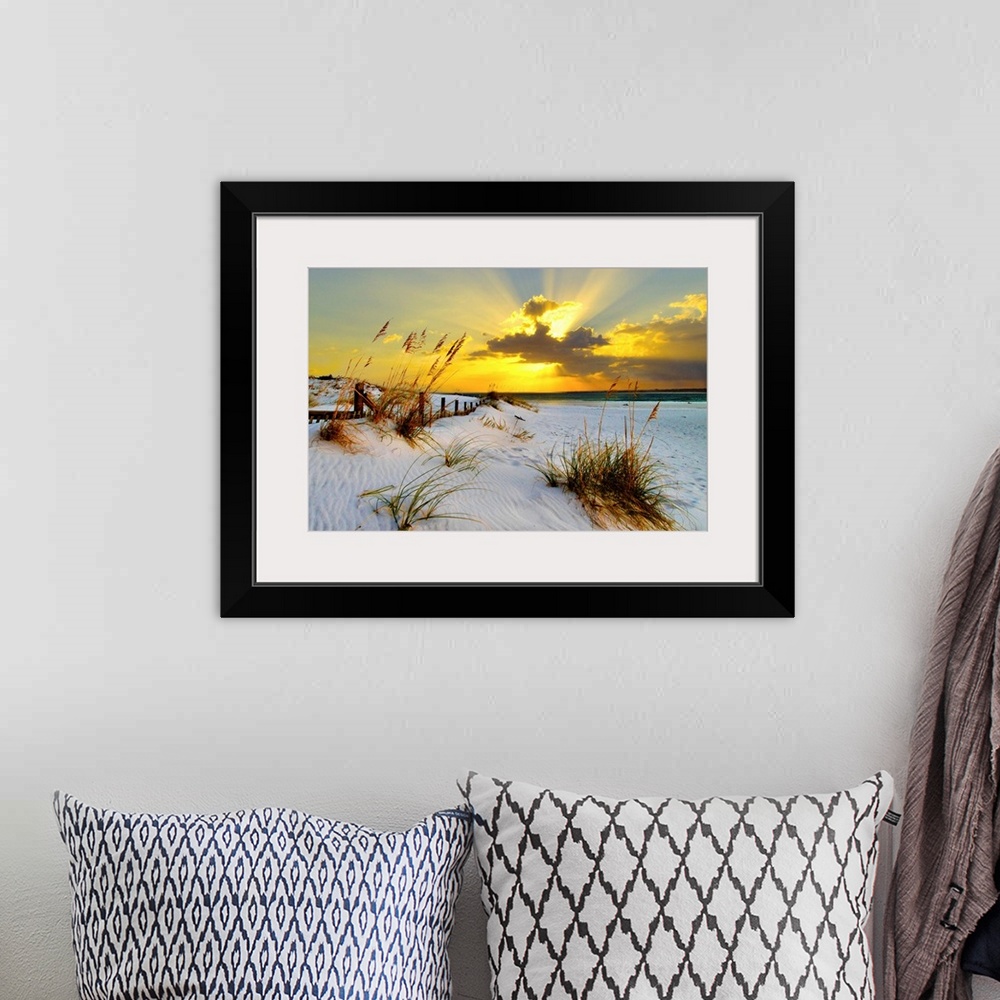 A bohemian room featuring Landscape photograph of a golden beach sunset along a beautiful coast. This golden sunset has mag...