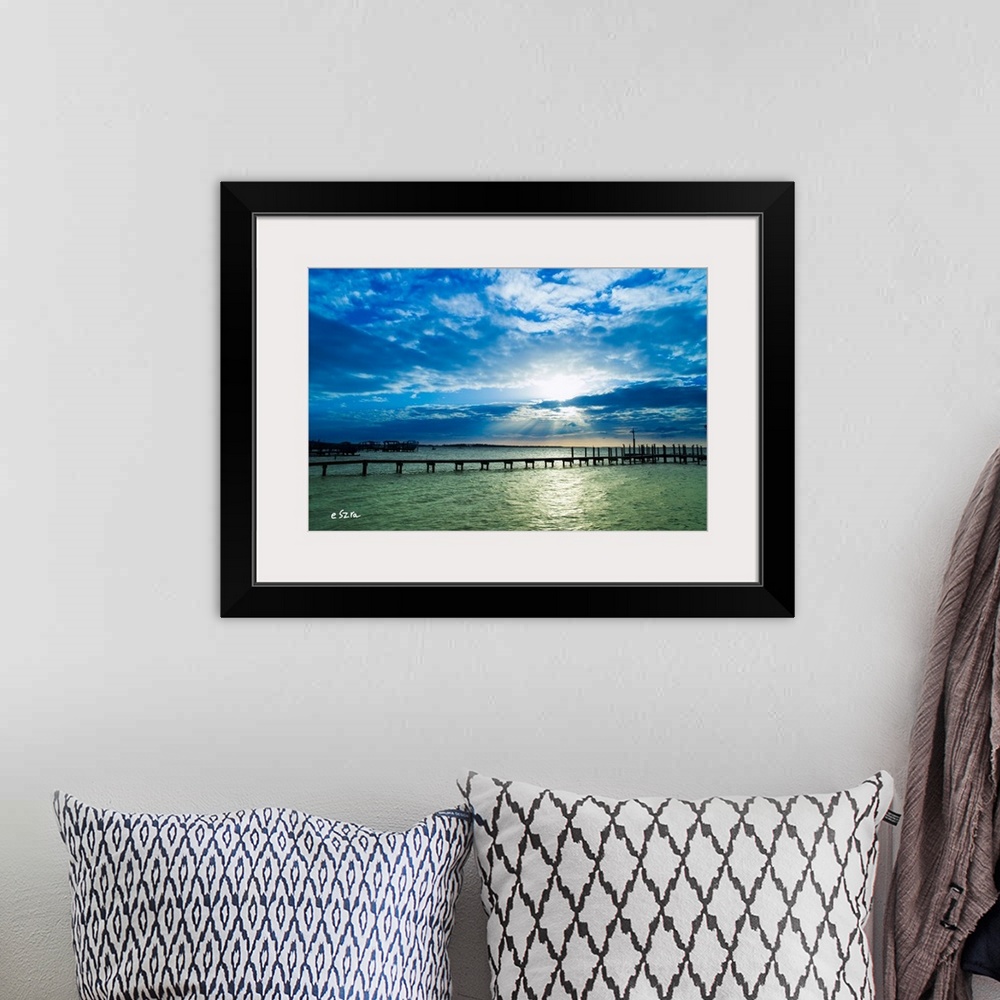 A bohemian room featuring A lonely pier on a shimmering sea in Pensacola, Florida.