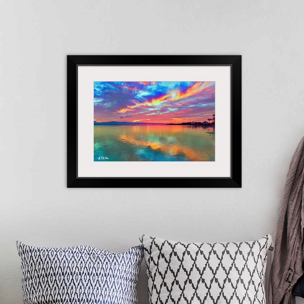 A bohemian room featuring Cloud streaks reflected in this pink sunset over the sea.