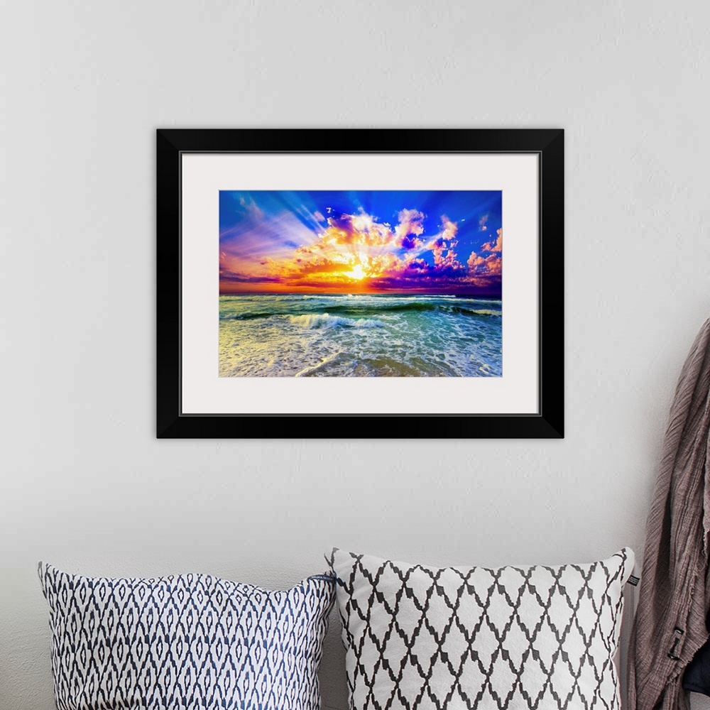 A bohemian room featuring A purple and blue sunset over a green sea. The reflection of the orange, purple and blue sunset h...