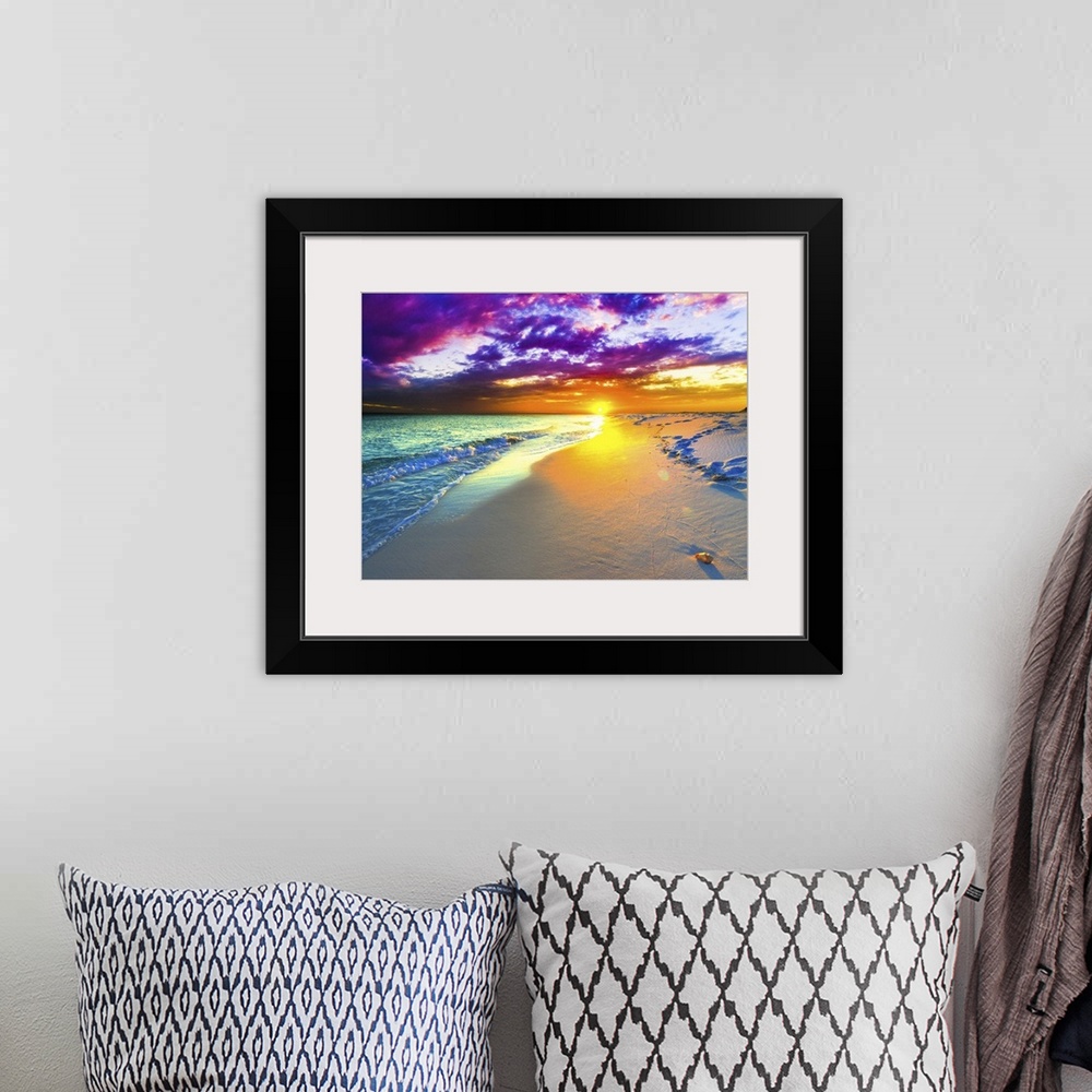 A bohemian room featuring A beautiful purple and blue sunset over a sandy beach shoreline. The ocean takes up a small part ...