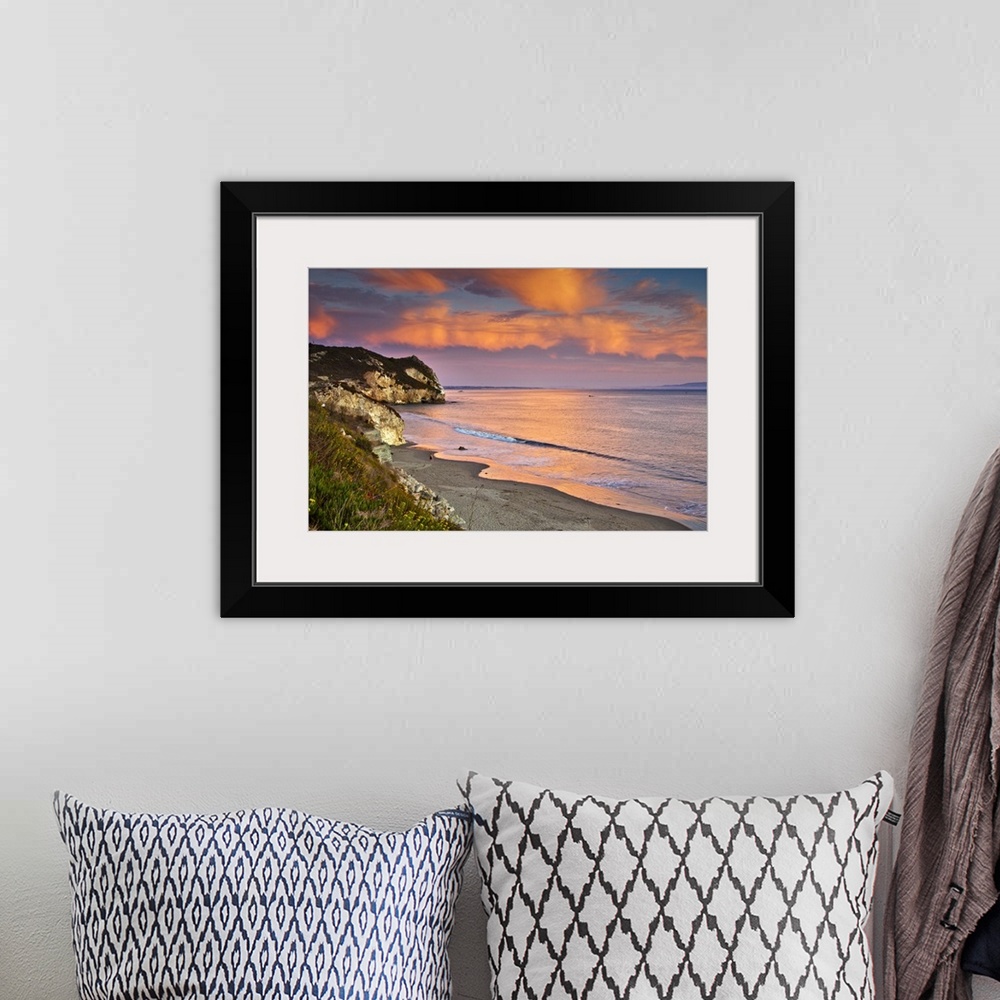 A bohemian room featuring Horizontal photograph on a big wall hanging of the rocky coast line along Avila Beach in Californ...