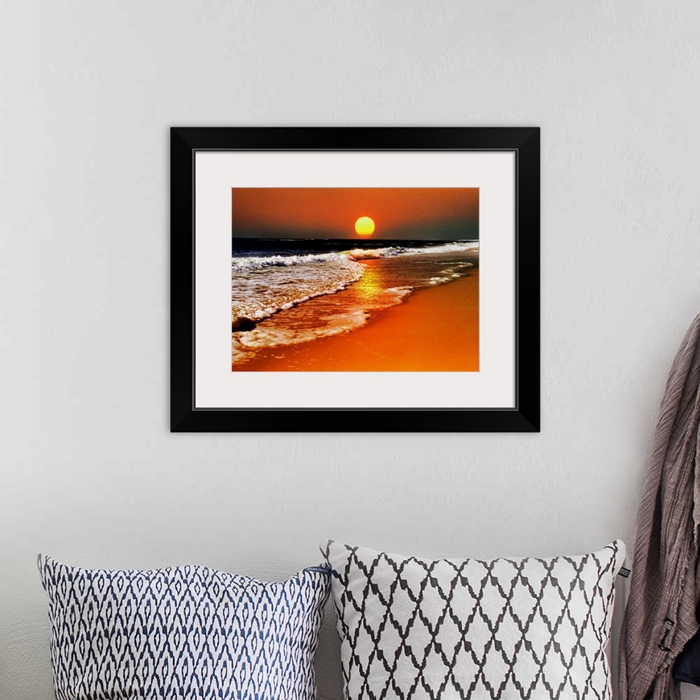 A bohemian room featuring This canvas wall art is a photograph of the sun dropping below the horizon in this landscape at t...