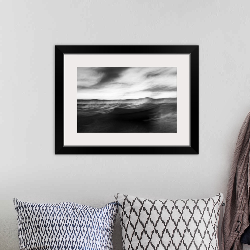 A bohemian room featuring Monochrome intentional camera movement blurs of coastal impressionist style image in morning ligh...