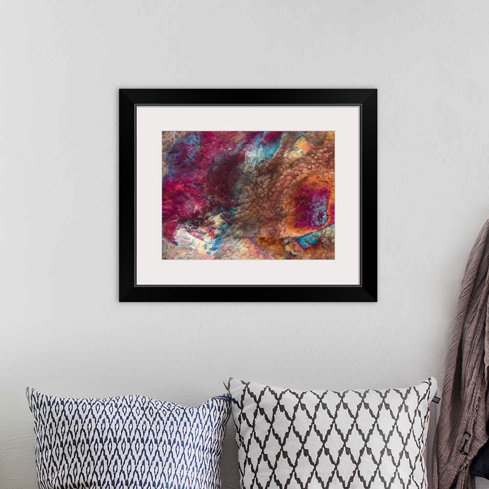 A bohemian room featuring Abstract artwork of a piece of metal that has various colors swirled around it.