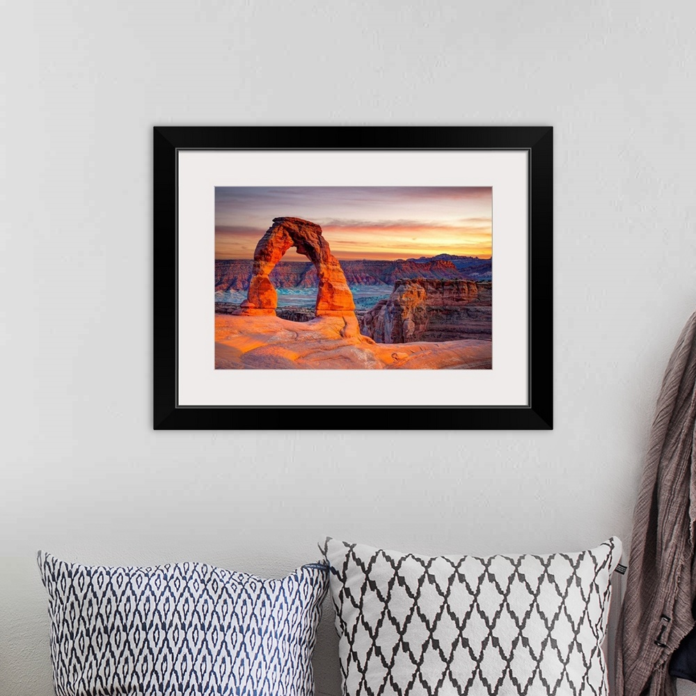 A bohemian room featuring This wall art for the home or office shows desert rock cliffs growing in the light of a sunset.