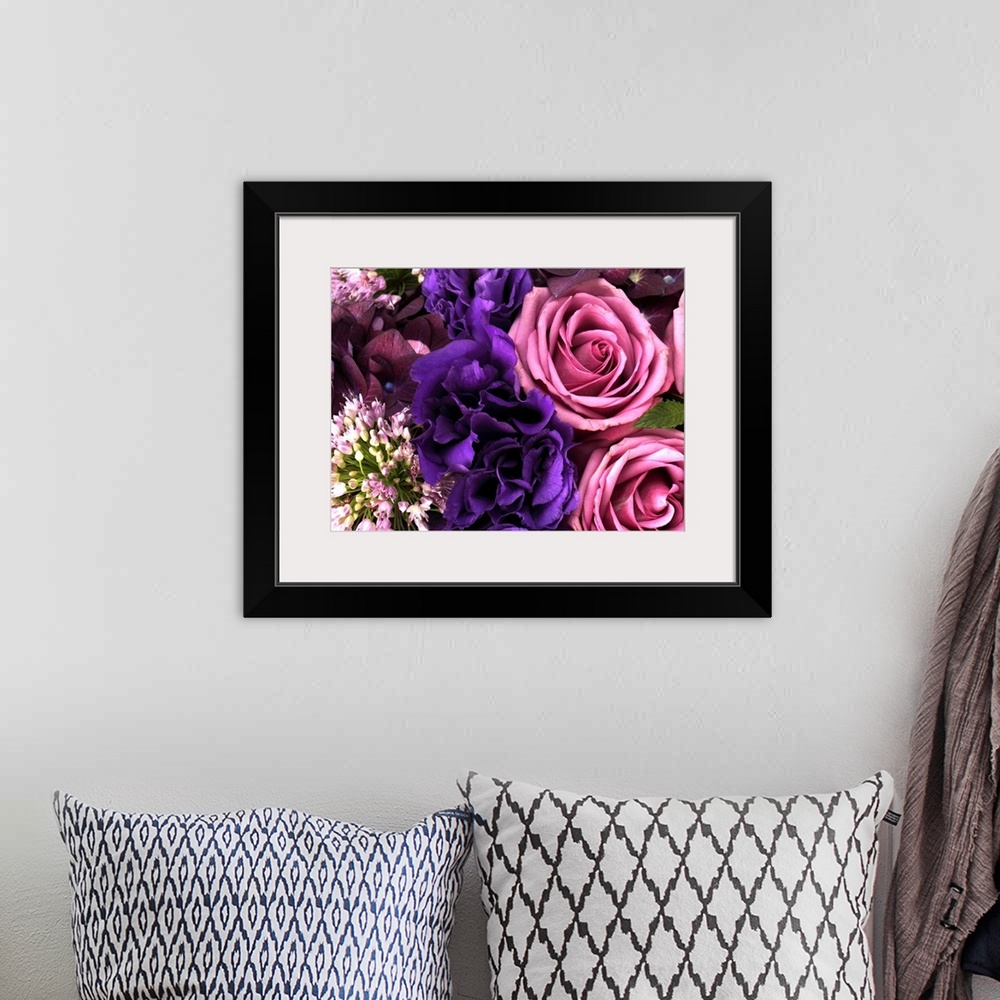 A bohemian room featuring Big canvas photo of different multicolored flowers arranged together.