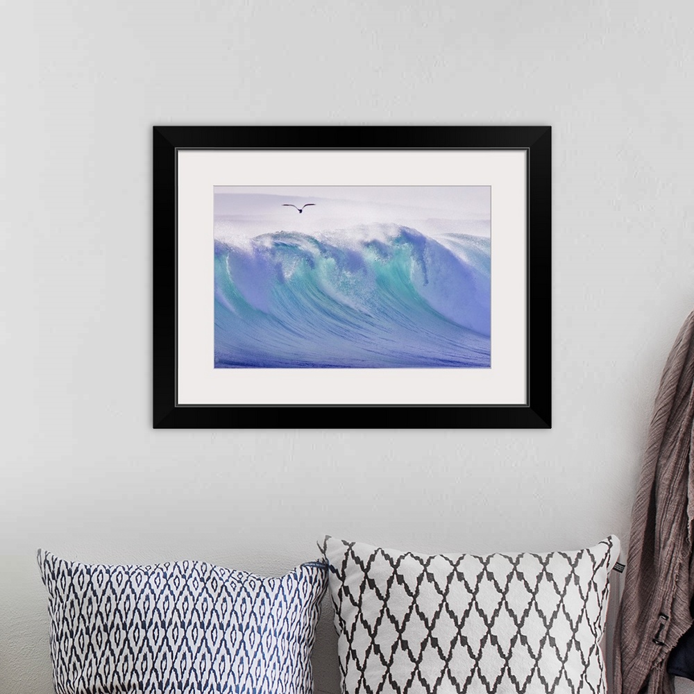 A bohemian room featuring Large photo on canvas of a big wave about to crash with a seagull flying above.