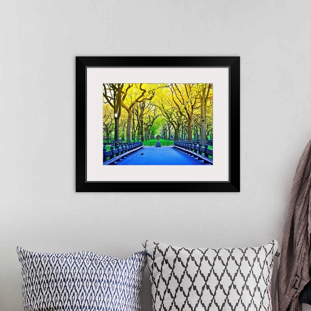 A bohemian room featuring Vividly colored photograph of a bridge surrounded by trees in Central Park.