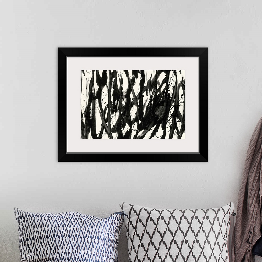 A bohemian room featuring A contemporary abstract painting using bold black lines against a cream background.