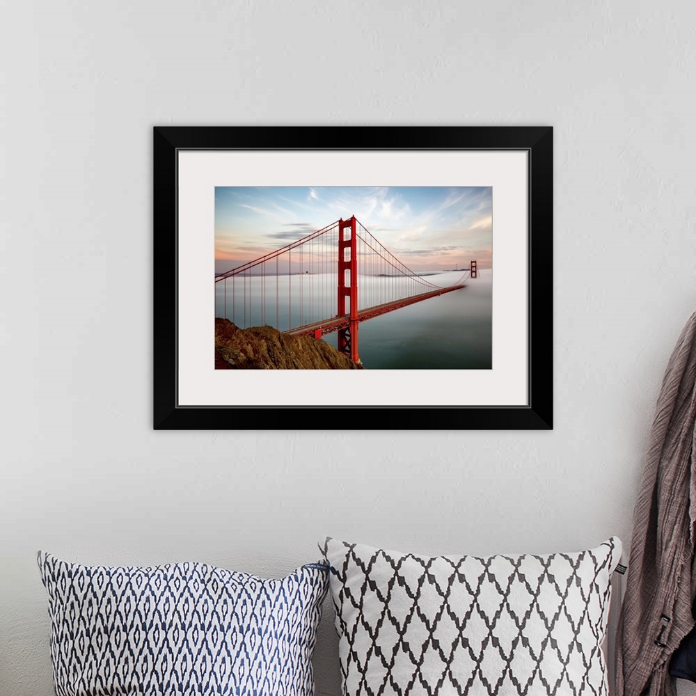 A bohemian room featuring The towers of the Golden Gate bridge in San Francisco, California, half-covered in mist.