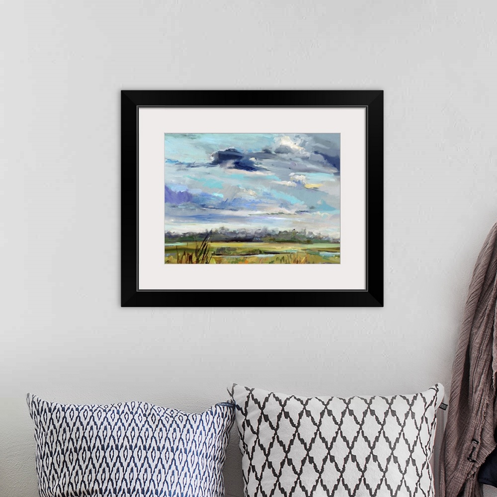 A bohemian room featuring A contemporary painting of a marshland under a blue sky.