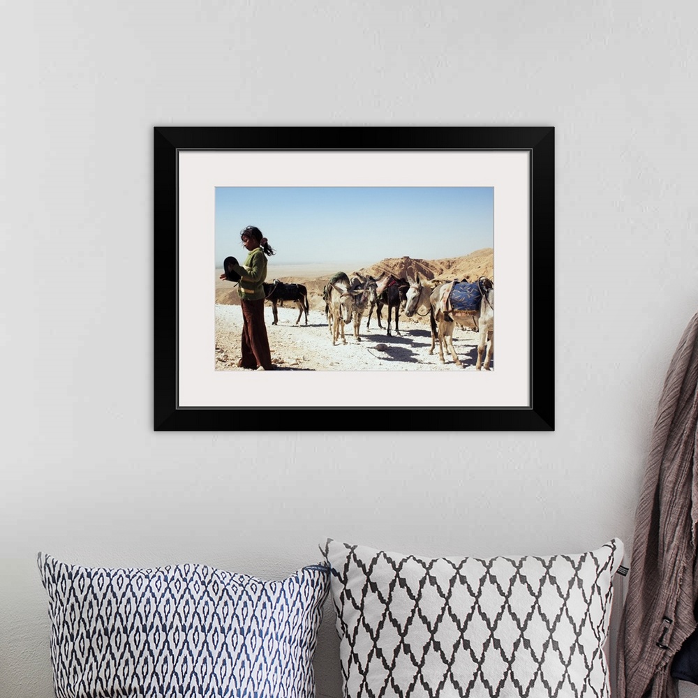A bohemian room featuring A Young Girl With Her Caravan of Donkeys