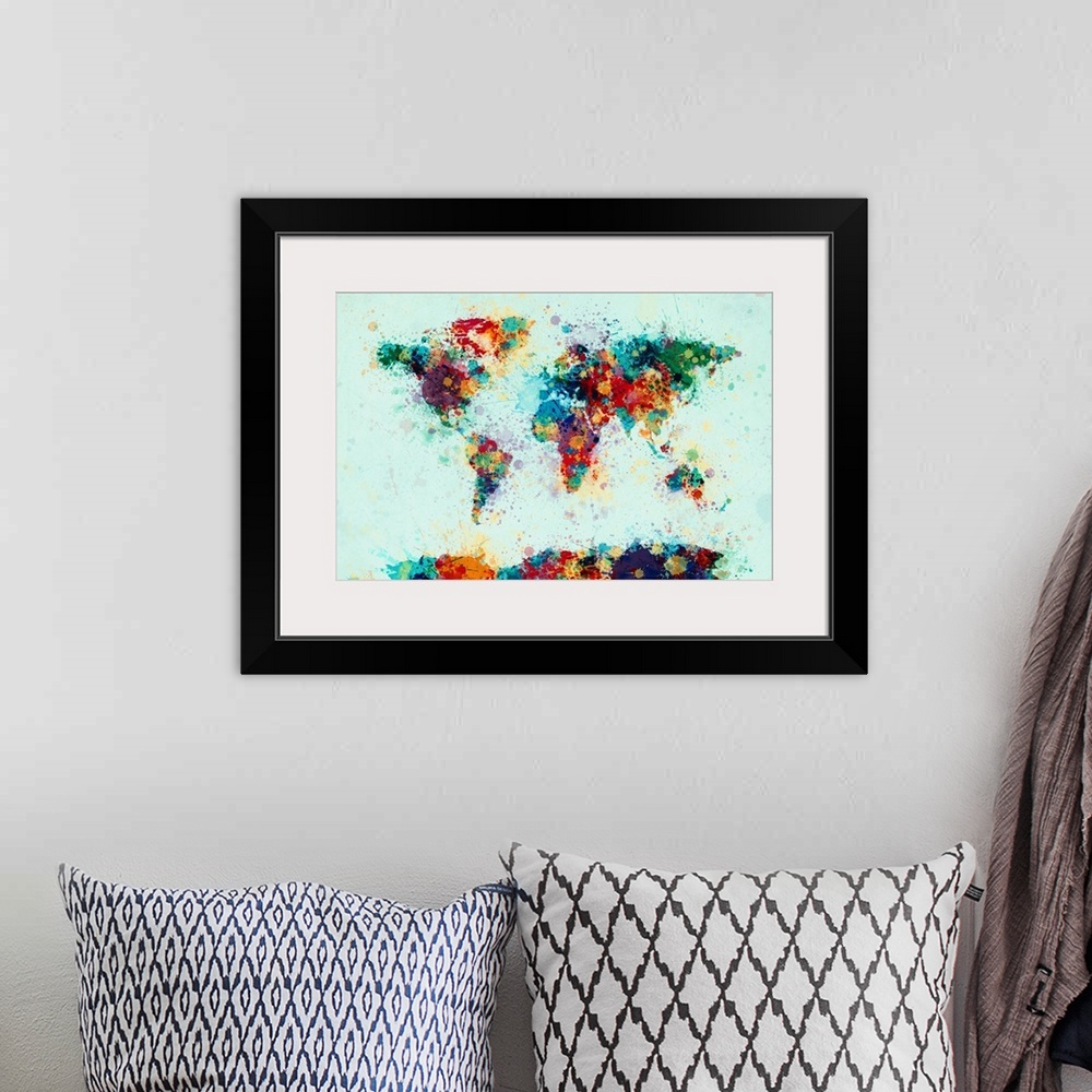 A bohemian room featuring Contemporary world map artwork made of bright watercolor paint splashes.