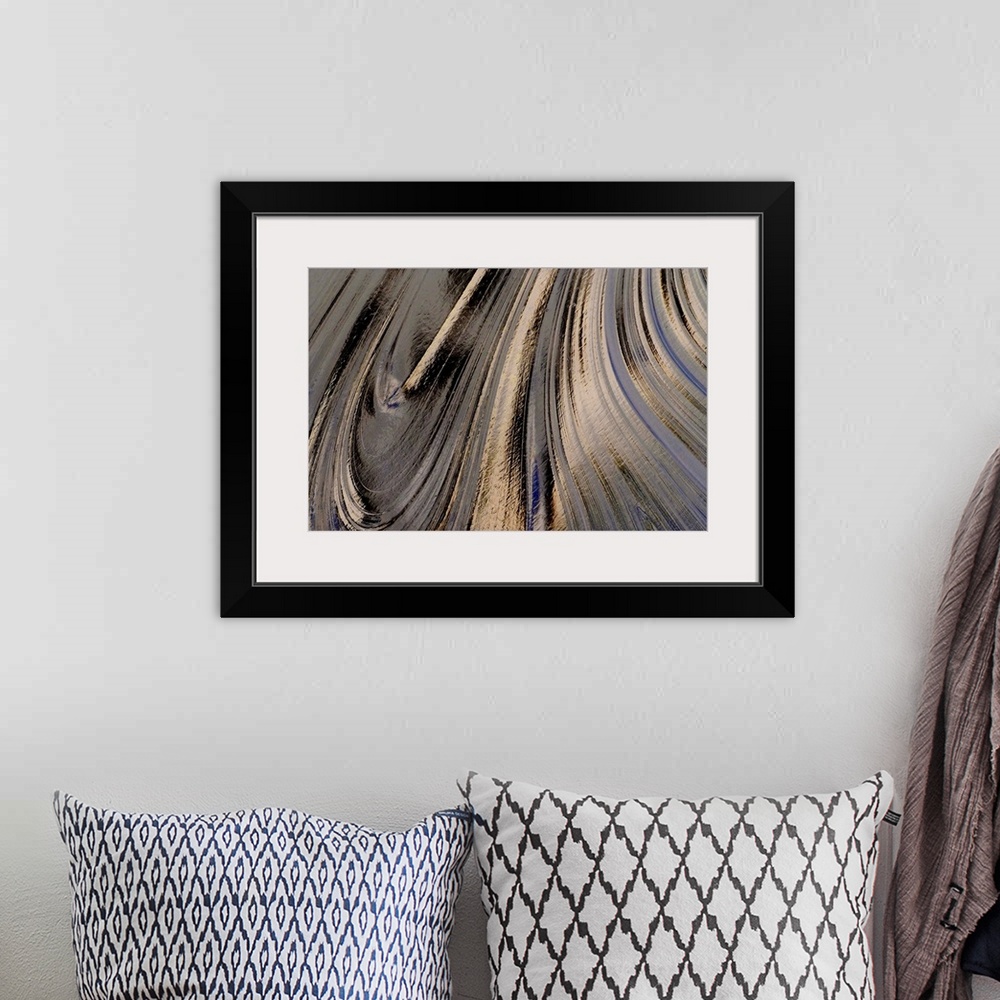 A bohemian room featuring A close up nature photograph of a light reflecting off oil creating abstract swirling movement.