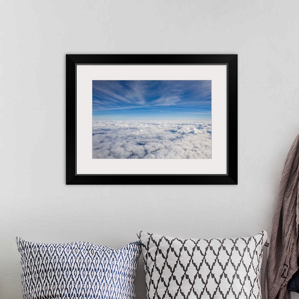A bohemian room featuring Just above the clouds, the sky split into blue and white layers.